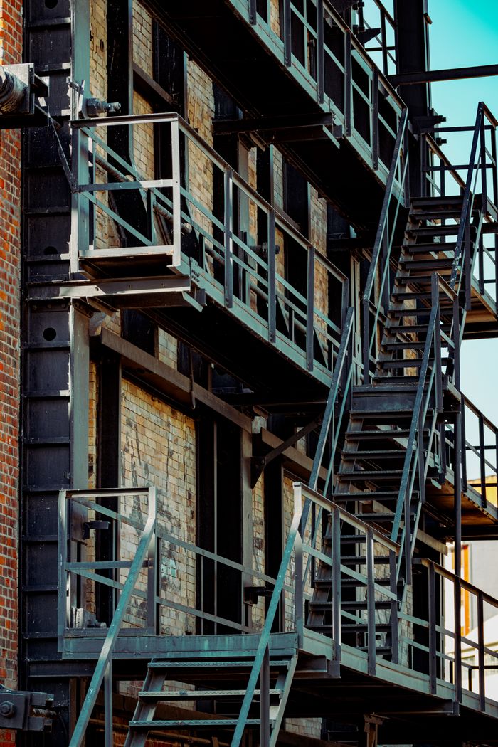 gallery-1 Close-up of a metal fire escape structure on a brick building facade in Istanbul, Turkey.